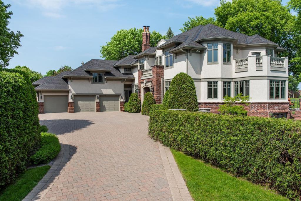 Stately entrance welcomes you inside this designer two story walkout home. Gorgeous brickwork and sophisticated paver driveway.