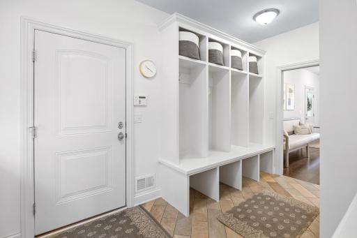 Nice built-ins add convenience to the mudroom off the garage entry