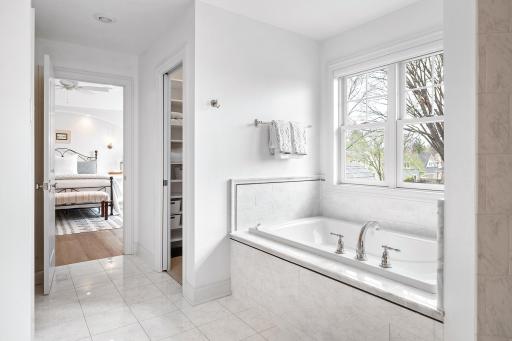 Primary bathroom looking toward attached bedroom
