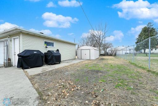 Large fenced backyard w/ 2-car garage & storage/garden shed.