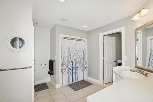 Main floor full bathroom with attached laundry room.