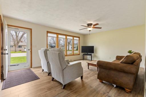 A welcoming, sunlit front living room welcomes your family and friends. Everything in this home has been updated head to toe! New flooring, wall paneling removed, sheetrocked with fresh paint, custom blinds, living room lights installed.