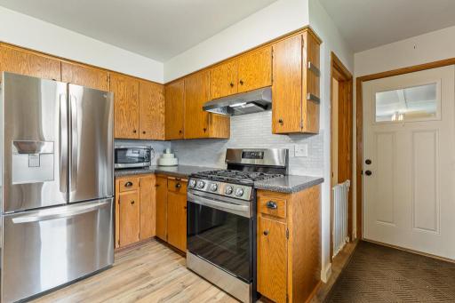 You'll discover access to the attached garage and the lower level beyond the kitchen