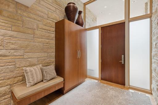 Greet friends here, the coat closet & bench are built into the foyer. The Architect blended the interior with the exterior with real hand chiseled stone accents.