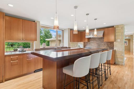Excellent natural light & a dual level island. Two dishwashers by Asko are here to make dishes sparkle with ease! Can you see the walk-in pantry? Your formal guests won't.
