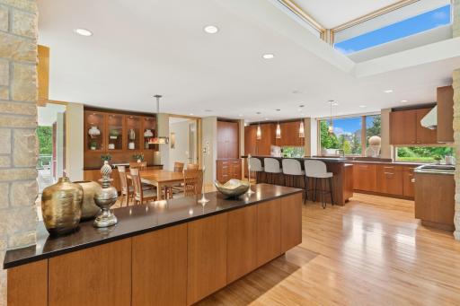 An abundance of custom cabinetry seem to hover effortlessly above gleaming real hardwood floors. Subzero, newer dual Asko's & Wolf are here to serve your Chef & great nature views reward culinary goals. A walk-in pantry is out of view by day guests.