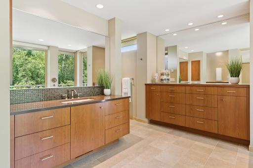 First of 2 owner's baths, both with a separate custom-crafted chests of drawers in addition to separate vanity spaces. Both feature their own custom showers, private commode spaces. Walk-in wardrobe rooms are provided for both owner's baths. Nice!