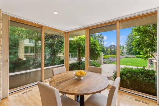 Reflections in the glass deceive the camera with views of this home's exterior & a deck, so it's best to see this breakfast room in person. Floor to ceiling glass on 3 sides, yet amazing privacy. Outside, the front patio with outdoor kitchen space.