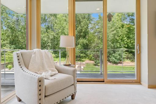 The owner's suite, a sweet retreat, so restful! Just look at those views! Yes your private owner's deck is accessed by either of two sliding doors. The planter box at the backyard fire pit is just barely in view from this camera position.