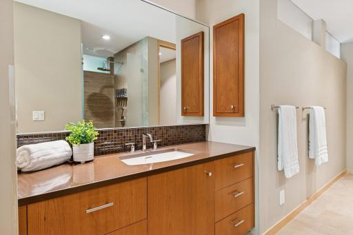 2nd owner's bath sink vanity & a separate built-in chest of drawers. In the mirror you can see the 2nd custom shower. Beyond this image to the right are a 2nd private commode space & 2nd walk-in wardrobe room. All just for you & only you!
