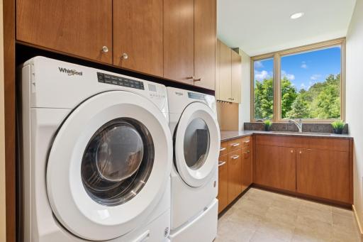 Main floor laundry with lots of cabinets, a deep sink, windows & a VIEW! Yes, even this room has great sightlines! The camera did not capture a large closet that is also here. Excellent function & storage.