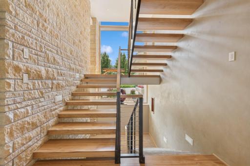 Real stone that was hand chiseled on the left side & real Venetian plaster on the right side. Space for an elevator is to the right that currently serve as triple stacked walk-in closets. The elevator was designed to access all but the belvedere.