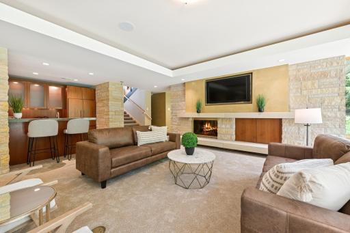 From the kitchenette, to this fireplace room to a pool table space, to a back patio, the flow of enjoyment is at home here. Lutron lighting controls multiple fixtures including the ceiling recess. New carpeting too.