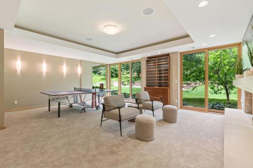 Always ready for fun & entertainment, this game room gives you a wonderful space for joyful moments & making memories. Lutron lighting controls include this ceiling recess. Double walkouts to the big backyard too. New carpeting too.