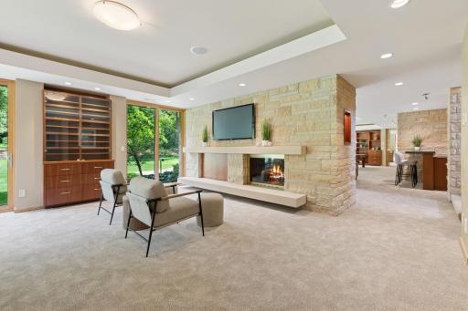 Each of the ceiling recess features have bounce lights to give you extra ambiance. Lutron lighting controls are here & in several other spaces. A custom built-in adorns the outer wall with display space & storage. New carpet too.