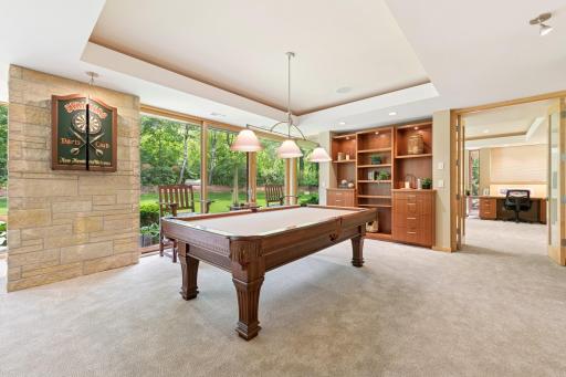 Adorned by real hand chiseled stone & flanked by a custom built-in this room also has a huge walk-in closet nearby. Yes, the ceiling feature has a rim lighting effect.