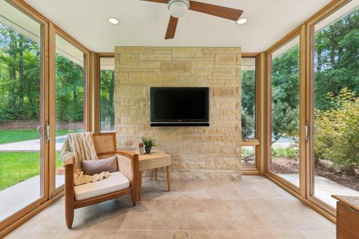 Exceptional four season porch designed for fresh air flow through whenever the weather allows. Also easy to enjoy with supplemental heating or cooling whenever desired. Beyond the hand-chiseled natural stone wall is your sport court.