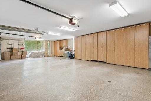Extra wide access via 2 double doors for this luxury garage. Of course there are floor drains & epoxy coating, even a sink with hot & cold water. Amazing resources for storage!