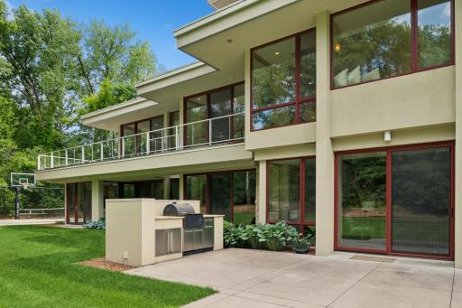 A 2nd patio with kitchen space is at the walkout lower level. Ample space for tables & chairs. Grand gatherings are easier with this home. Over the shoulder a fire pit & gardens are across the level lawn. Ideal for boccie ball.