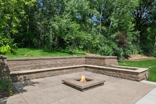 Fire pit with built-in seating & space for extra chairs, plus feature plantings. Smores & campfire stories or casual conversations. Another way to enjoy this home or entertain with friends.