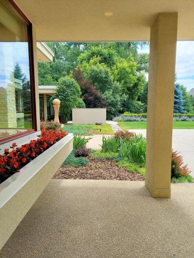 Service entrance view out to a garden sculpture & outdoor kitchen patio space. From the window (image left) your office allows you to see every package delivery as it happens. Overhead a roof protects your deliveries from weather elements.