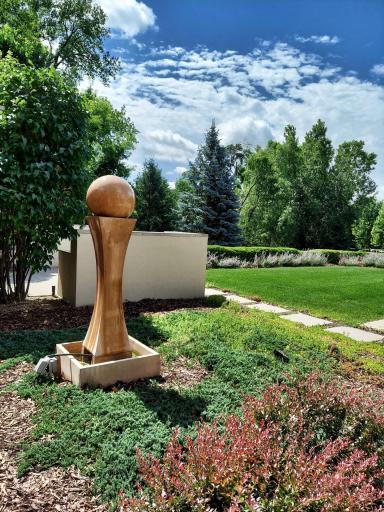 Enjoy the views from the front door. A water feature & the 1st of 2 outdoor kitchens, front lawn & gardens. Lots of trees, splendid privacy. Resting comfortably above Hidden Creek Trail for enhanced privacy & improved presentation. Nice!
