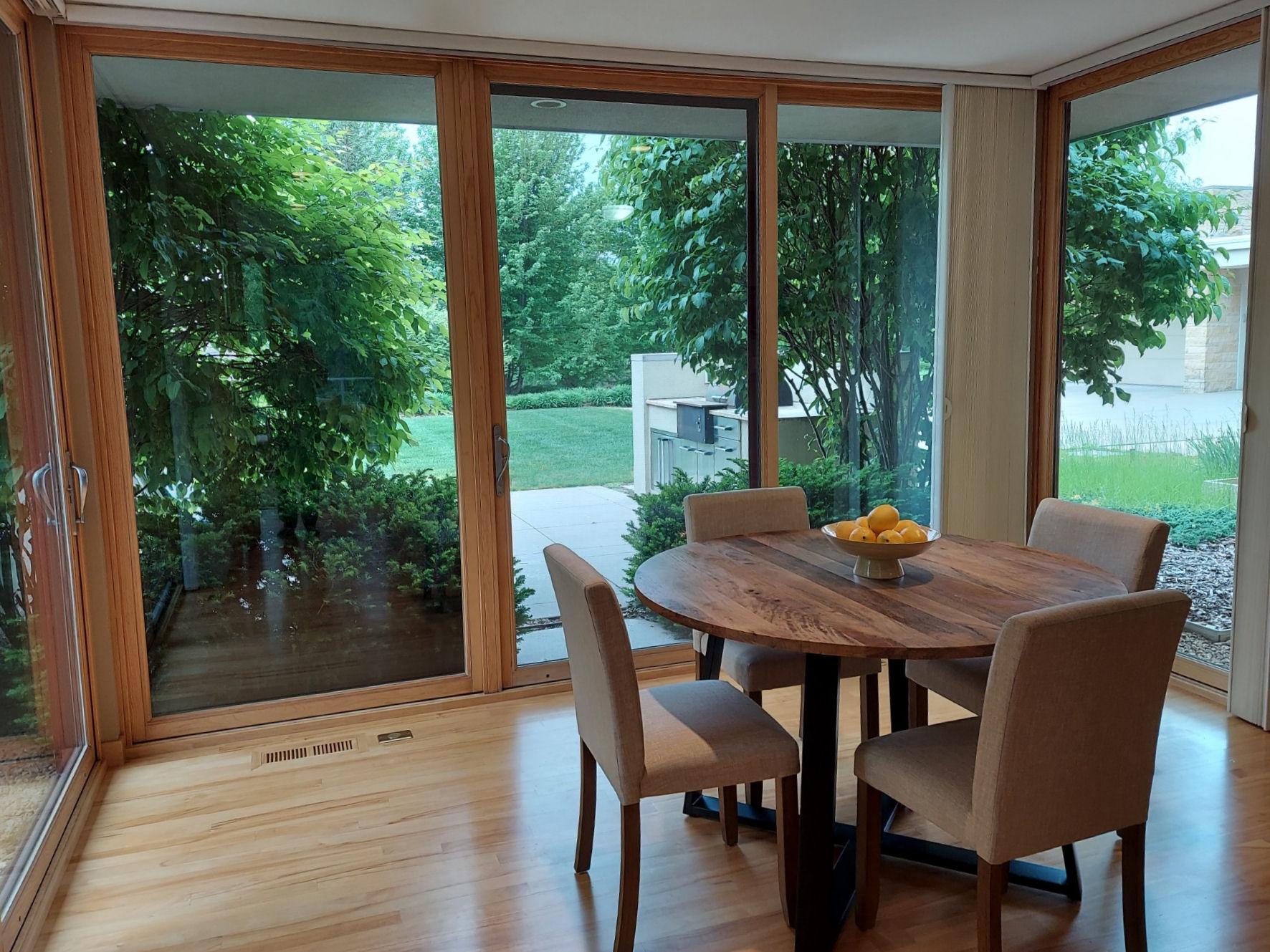This forward facing breakfast room comes with floor to ceiling glass on 3 sides. Let the dawn of a new day invite you to enjoy tea & coffee on the front patio via the center glass door.
