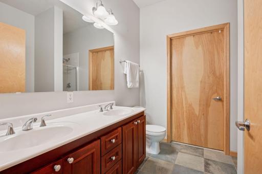 A dual sink vanity, ceramic tile floors, a separate shower and tub and walk-in closet - it has it all.