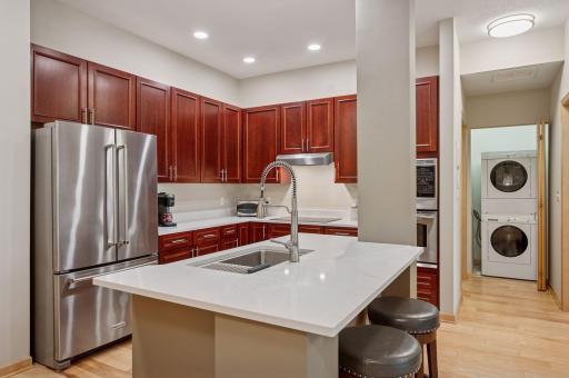 A bottom drawer freezer is easy to operate and store food in the stainless refrigerator. Check out the convenient laundry location.