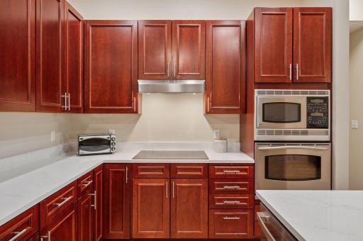 A new 5-burner electric cooktop! Note the microwave and convection oven on the wall.