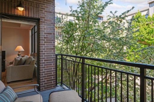 Exit onto your brand new balcony floor and railing and you can see the courtyard through the trees.