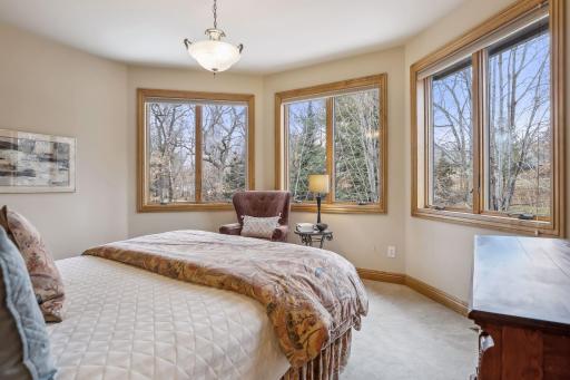 Bedroom #4 is light-filled with an array of windows looking to the backyard.