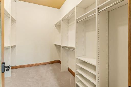 Custom closet organizers make this walk-in close a dream