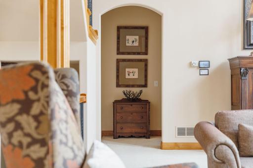A short hallway offers a point of interest from the formal living room to the primary suite on the main level