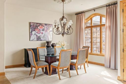 The formal dining room also features a large window that allows the light to stream in.