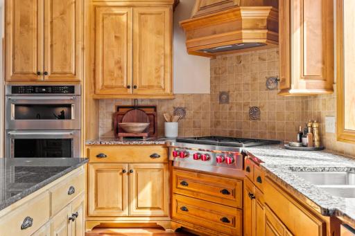 A beautiful gas cooktop with custom hood vent