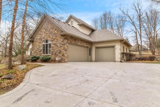 Enjoy the stamped concrete driveway with a three-car garage.