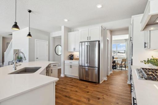 Look at this open kitchen, great for the whole family to help with the cooking. Photo of a model home, color & options will vary.