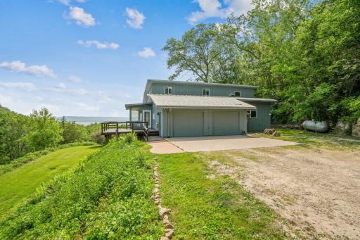 This approximately 3400 FSF contemporary home sits on a quiet secluded wooded site with a view of Lake Pepin.