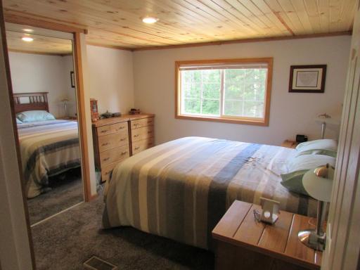Primary bedroom with pine tongue & groove ceiling