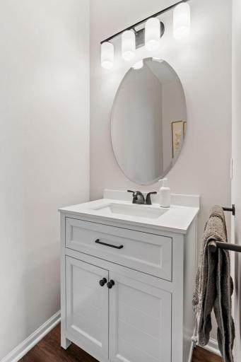Conveniently located powder room adjacent to the kitchen.