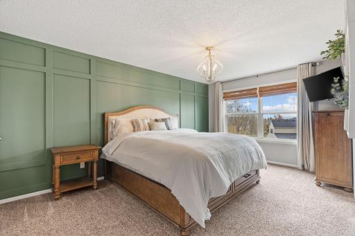 The primary bedroom is a true retreat complete with an ensuite bath with updated quartz countertops on the dual vanity and walk in closet