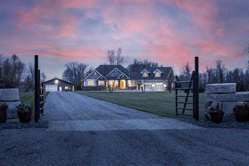 Gated front entry to crushed granite gravel drive