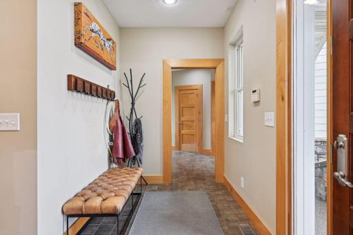 Hallway to mud room, garage, and upper level stairs