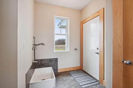 This mudroom includes a dog washing station - perfect for a farm!
