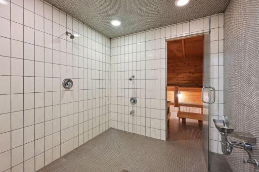 Huge walk-in shower with three shower heads and built-in water fountain!