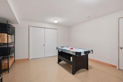 This game room has plenty of room for a pool table... and each door leads to more storage!