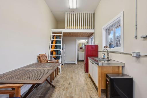 The shop apartment boasts a lofted bed, kitchen sink, and a 3/4 bath. It is both heated and cooled, providing a completely usable and comfortable space.