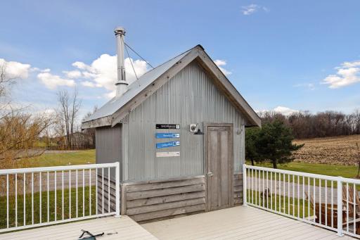 Outdoor sauna has it's own mudroom/changing room at the entrance.