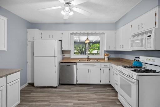 Bright and updated, the kitchen features plenty of cabinet space for all your storage needs.